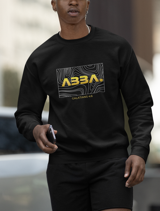 Person wearing a black sweatshirt with 'ABBA' logo and text, standing outdoors.